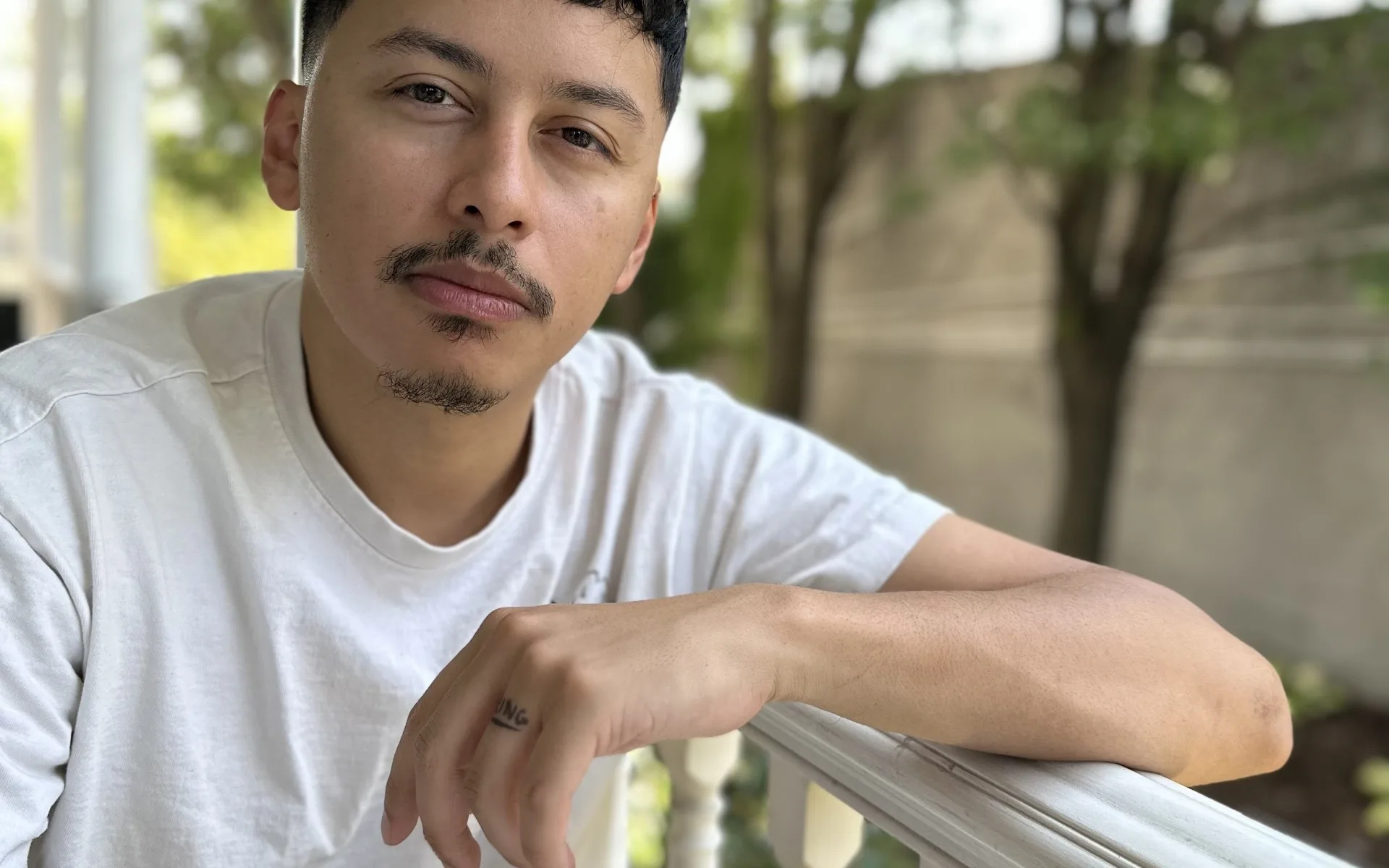Chipi Camposeco — portrait, photographed outdoors on a porch.